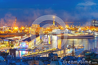 Old Lighthouse in port of Genoa at night, Italy. Stock Photo