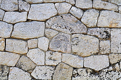 Old limestone wall with irregular shaped blocks Stock Photo