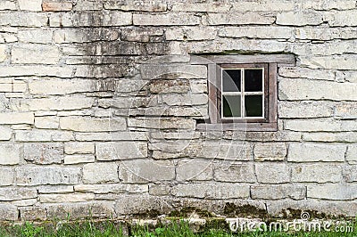 Old limestone wall with square window Stock Photo