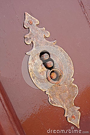 Old lock on a brown painted door Stock Photo