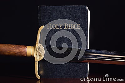 The Holy Bible with Ancient Sword Stock Photo