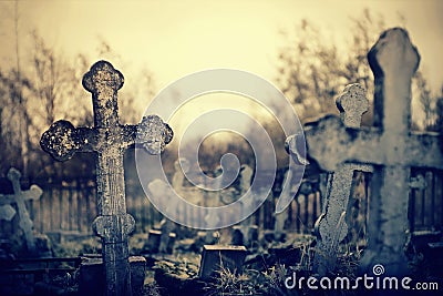 Old lop-sided sepulchral crosses on the thrown graves at the cemetery Stock Photo