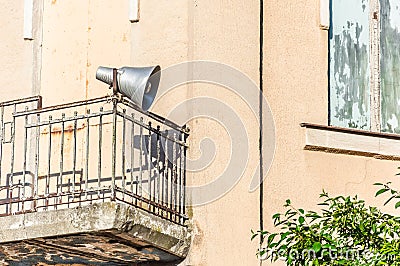 Old loudspeaker on the balcony of the second floor Stock Photo