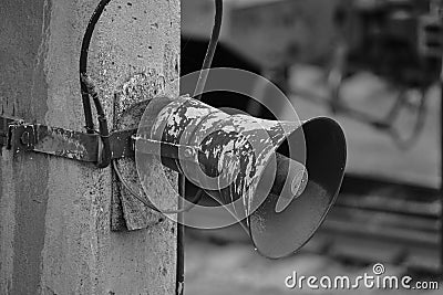 Old loudspeaker hanging pole, in a black and white photo Stock Photo