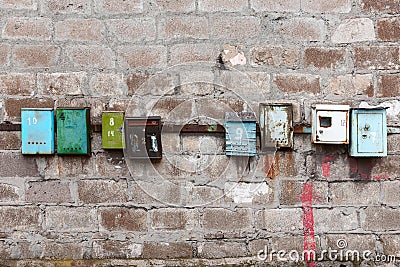 Old mailboxes on an old dirty wall Stock Photo