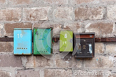 Old mailboxes on an old dirty wall Stock Photo