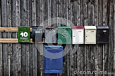 Old mailboxes on a wooden wall Stock Photo
