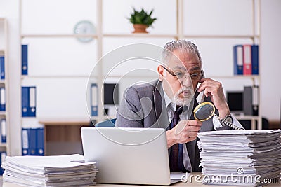 Old male auditor working in the office Stock Photo