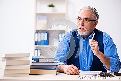 Old male author writing books Stock Photo