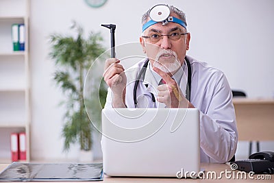 Old male doctor otologist working in the clinic Stock Photo