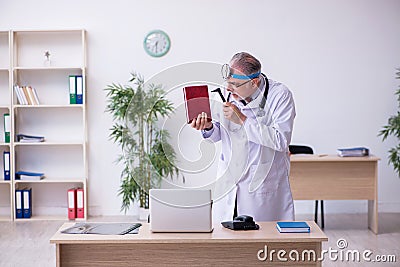 Old male doctor otologist working in the clinic Stock Photo