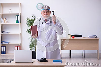 Old male doctor otologist working in the clinic Stock Photo