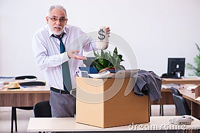Old male employee being fired from his work in retirement concept Stock Photo