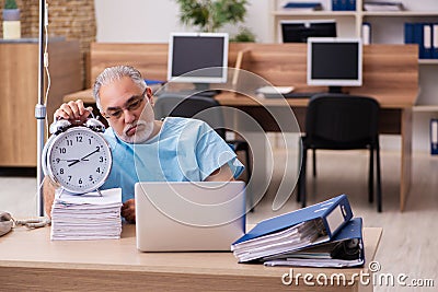 Old male employee in blood transfusion concept Stock Photo