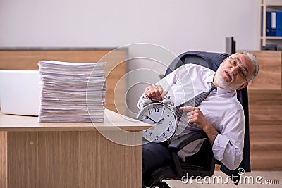 Old male employee in time manegement concept Stock Photo