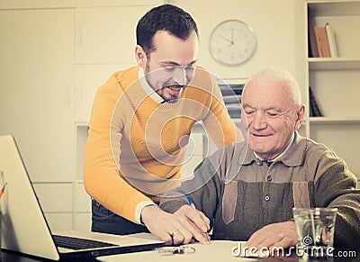 Old man and agent sign lease contract Stock Photo