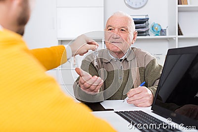 Old man and agent sign lease contract Stock Photo