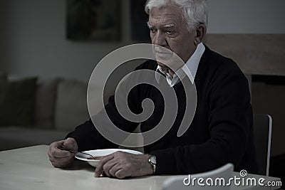 Old man without appetite Stock Photo