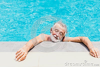 Old man athlete exhausted from swimming on a hot day Stock Photo
