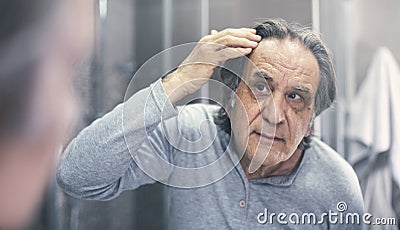 Old man is checking hair loss Stock Photo