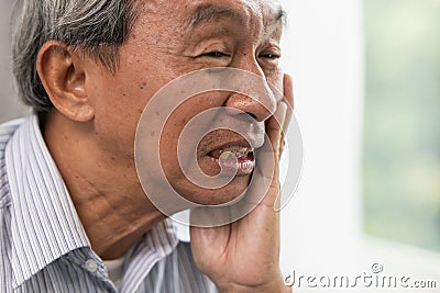 Old man elder toothache pain suffer from dental problem teeth caries decayed Stock Photo