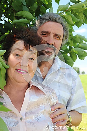 Old man embracing old woman from back Stock Photo