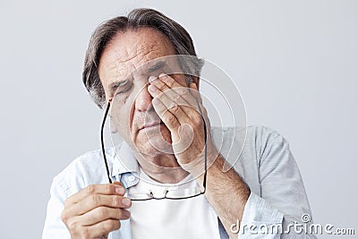 Old man with eye fatigue Stock Photo