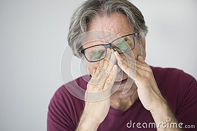 Old man with eye fatigue Stock Photo