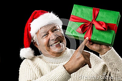 Old Man With Gentle Smile Pointing At Green Gift Stock Photo