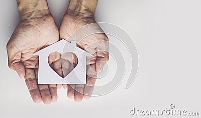 Old man hands holding small model family , concept family Stock Photo