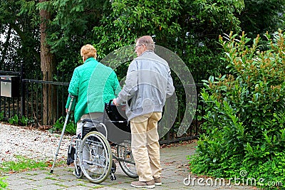 Old man helps woman wheelchair, Netherlands Editorial Stock Photo