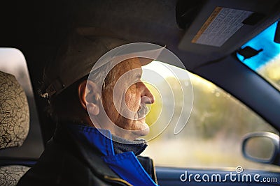 Old man with moustaches driving a car Stock Photo