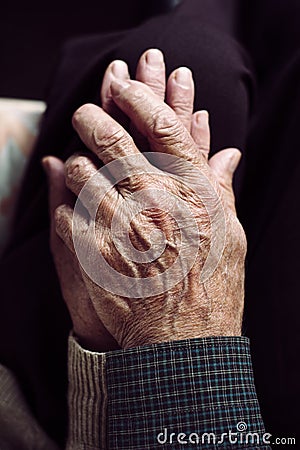 Old man and old woman holding hands Stock Photo