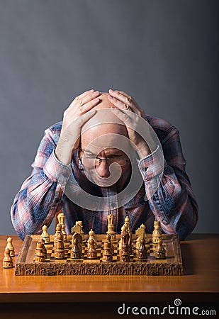 Old man playing chess Stock Photo