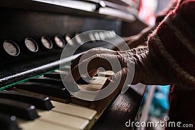 Old man playing the piano in a close up view of his wrinkled han Stock Photo