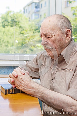 Old man praying Stock Photo