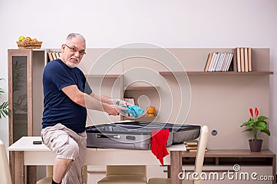 Old man preparing for trip at home Stock Photo