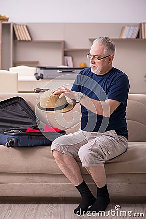 Old man preparing for trip at home Stock Photo