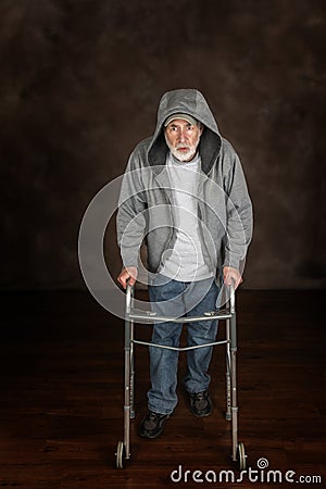 Old Man Resting On Walker Brown Background Copy Space Stock Photo
