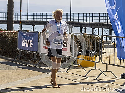 Old man running barefoot in Limassol Marathon, Cyprus Editorial Stock Photo