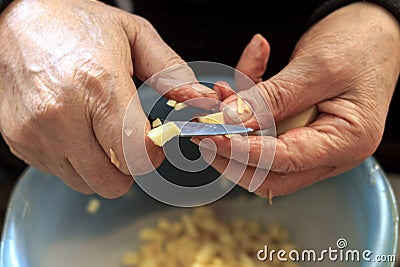 Old man slicing potatoes Stock Photo