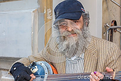 The old man in the street playing instrument Editorial Stock Photo