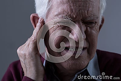 Old man with tinnitus Stock Photo