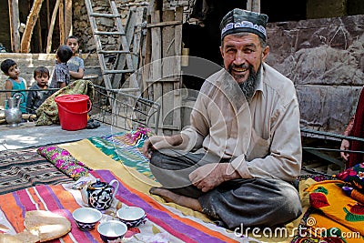 Old man in traditional clothes drinks tea in Tajikistan Editorial Stock Photo