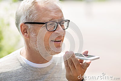 Old man using voice command recorder on smartphone Stock Photo