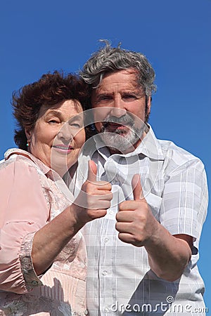 Old man and woman making thumbs up gesture Stock Photo