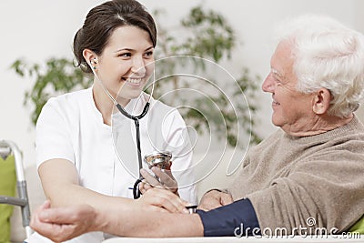 Old man and young nurse Stock Photo