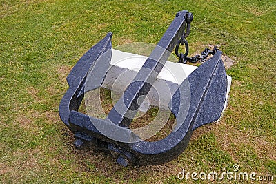 Old marine ship anchor lying on a meadow at the port of Montevideo, Uruguay Stock Photo