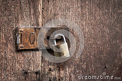 Old master key rusty lock wooden door. Stock Photo