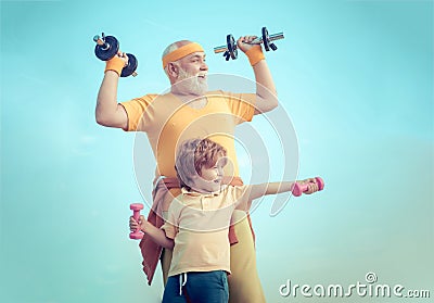 Old mature man and little boy exercising with dumbbell. Grandfather and child lifting weights. Be in motion. Like sports Stock Photo